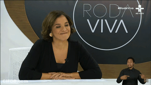 Woman At Desk With Roda Viva Sign GIF