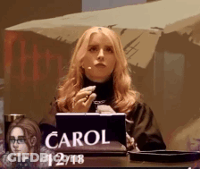 Woman At Desk With Sign Saying Carol GIF