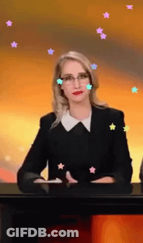 Woman At Desk With Stars Around Head GIF