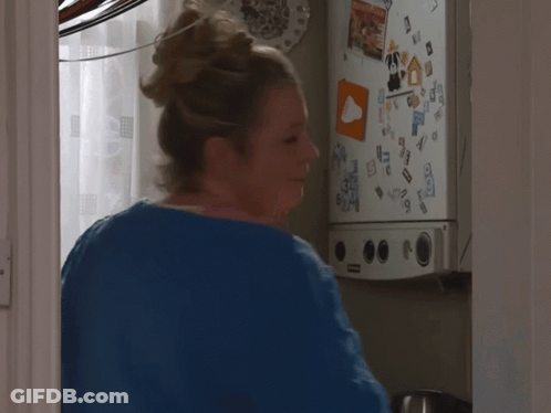 Woman At Fridge With Sticker Saying A GIF
