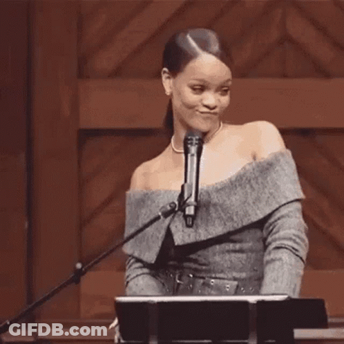 Woman At Microphone Holding Hair In Ponytail GIF