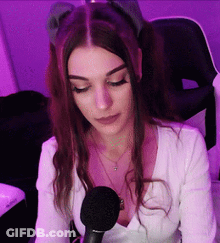 Woman At Microphone In Purple Lights GIF