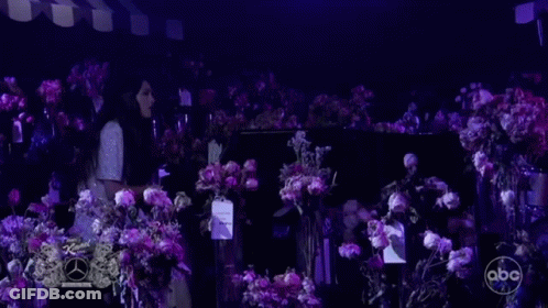 Woman At Piano With Purple Flowers GIF