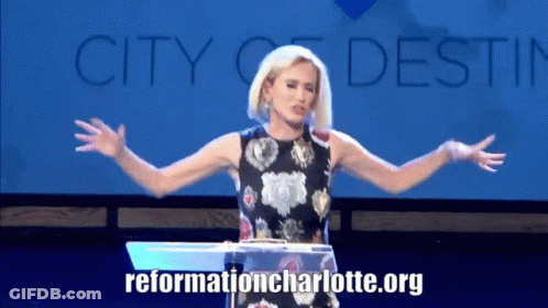 Woman At Podium With Arms Outstretched GIF