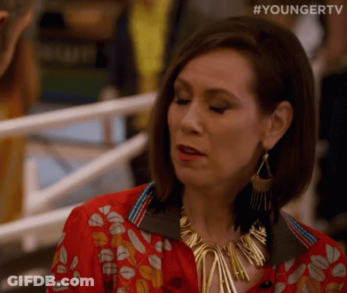 Woman At Railing Red Shirt Gold Necklace GIF