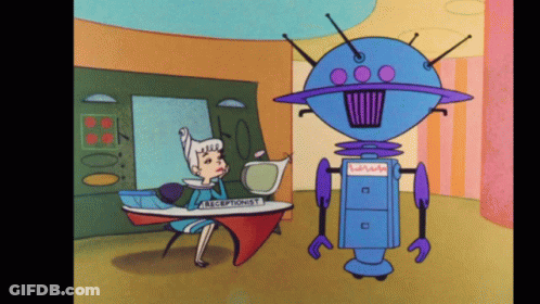 Woman At Receptionist Desk Talking To Blue Robot GIF