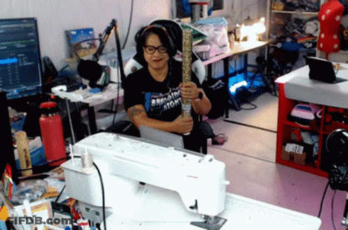 Woman At Sewing Machine Wearing Bring The Atom T-Shirt GIF