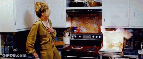 Woman At Stove With Smoke GIF