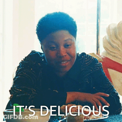 Woman At Table Saying It's Delicious GIF