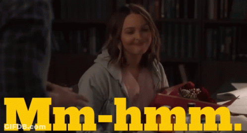 Woman At Table Saying Mm-Hmm GIF