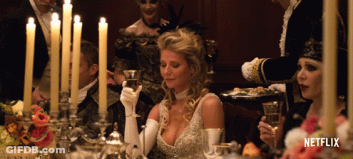 Woman At Table With Candles And Netflix Logo GIF