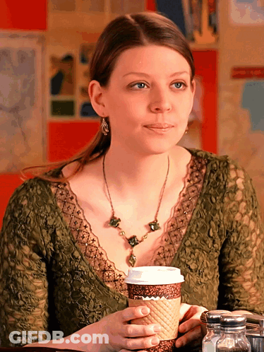 Woman At Table With Cup Of Coffee GIF