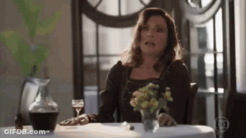 Woman At Table With Glass Of Wine GIF