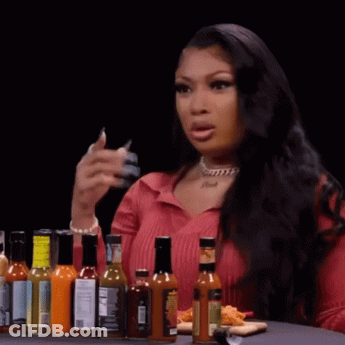 Woman At Table With Hot Sauce And Food GIF