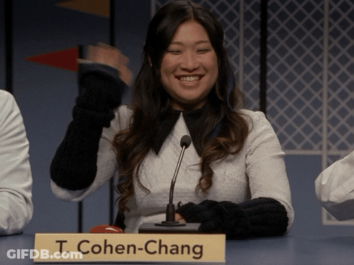 Woman At Table With Microphone And Sign T. Cohen-Chang GIF