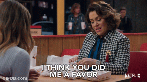 Woman At Table With Netflix Logo GIF