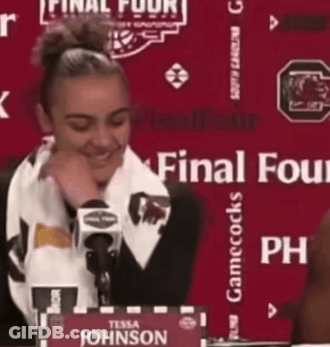 Woman At Table With Tessa Johnson Sign GIF