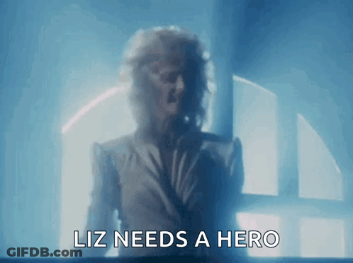 Woman At Window Saying Liz Needs A Hero GIF