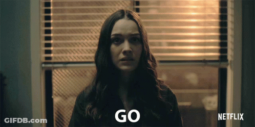 Woman At Window With Blinds Saying Go GIF