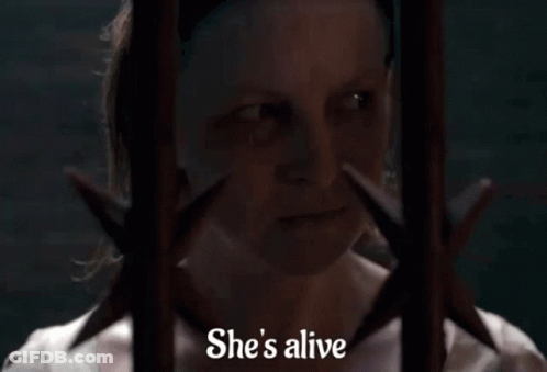 Woman Behind Bars Saying Alive GIF