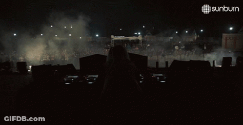 Woman Behind DJ Booth With Sunburn Logo GIF