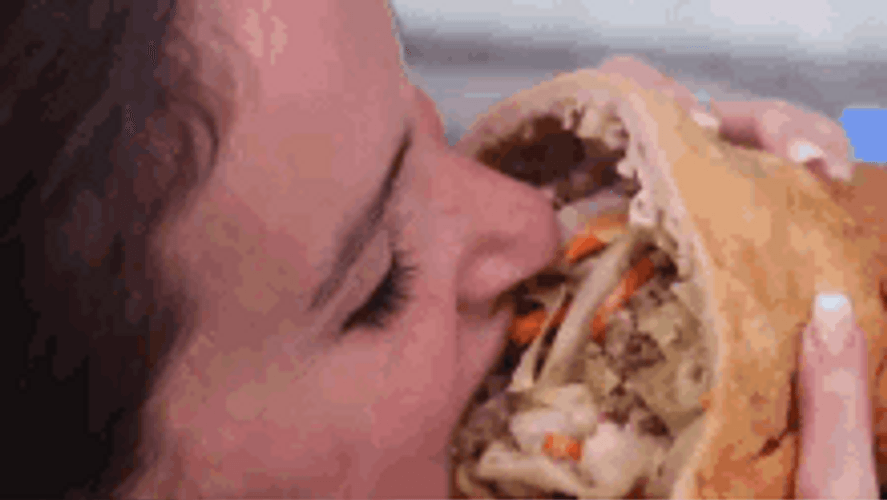 Woman Biting An Egg Roll GIF