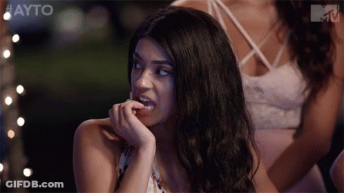 Woman Biting Nails In Front Of Group GIF