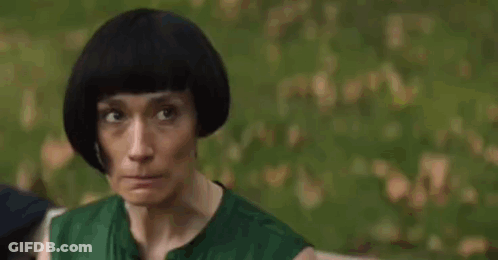 Woman Biting Nails In Front Of Trees GIF