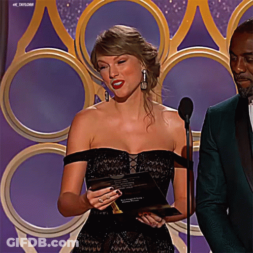 Woman Black Dress At Microphone, Man Green Suit GIF