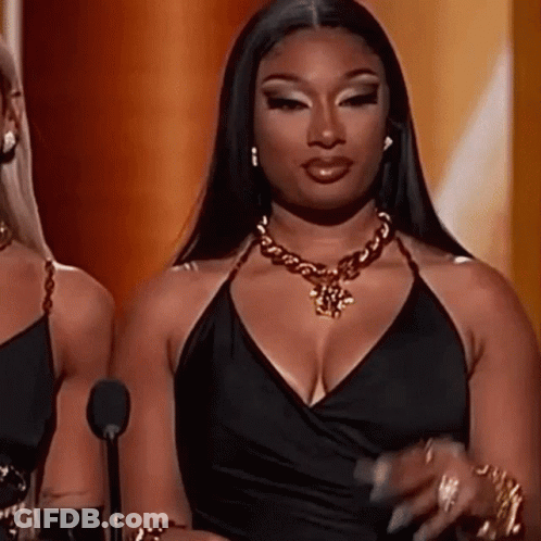 Woman Black Dress At Microphone With Gold Necklace GIF