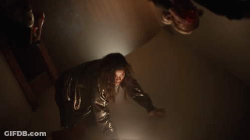 Woman Black Jacket Red Pants Dark Hallway GIF