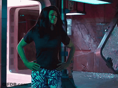 Woman Black Shirt White Pants Hands On Hips GIF