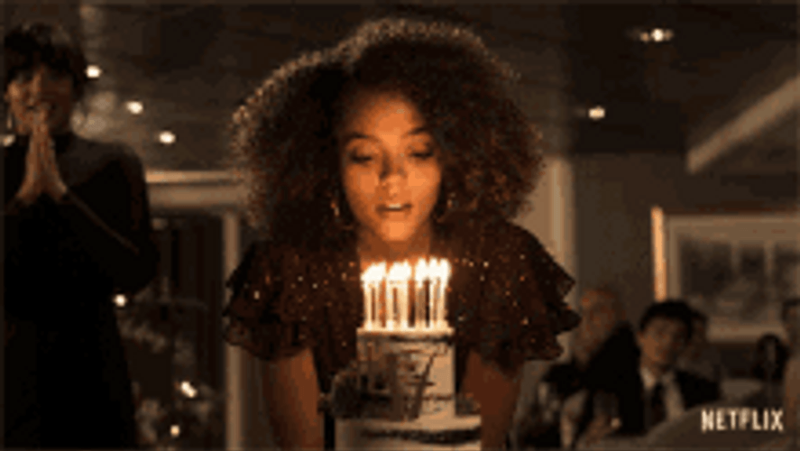 Woman Blowing Birthday Candles On Cake GIF
