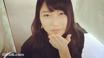 Woman Blowing Kiss At Camera In Front Of Mirror GIF
