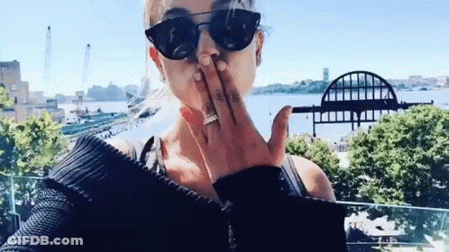 Woman Blowing Kiss In Front Of Water GIF
