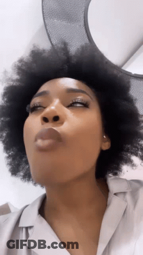 Woman Blowing Kiss With Eyes Closed GIF