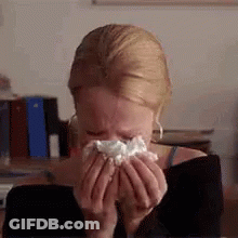 Woman Blowing Nose Into Napkin While Crying GIF