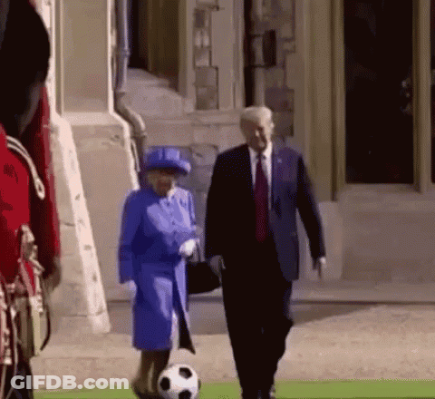 Woman Blue Coat With Soccer Ball Next To Man Suit Tie GIF