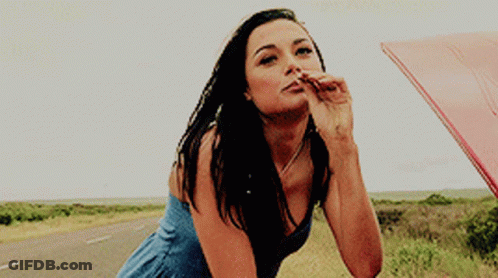 Woman Blue Dress Blowing Kiss Leaning Car Hood GIF