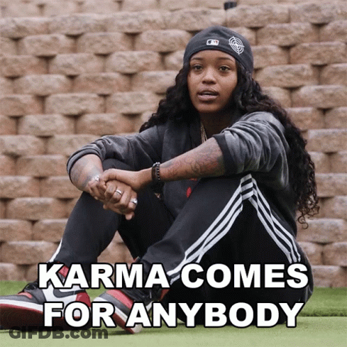 Woman By Brick Wall Saying Karma Comes For Anybody GIF
