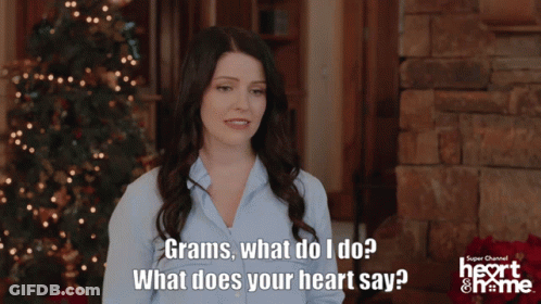 Woman By Christmas Tree Saying Grams What Does Your Heart Say GIF