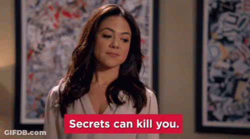 Woman By Painting With 'Secrets Can Kill You' Sign GIF
