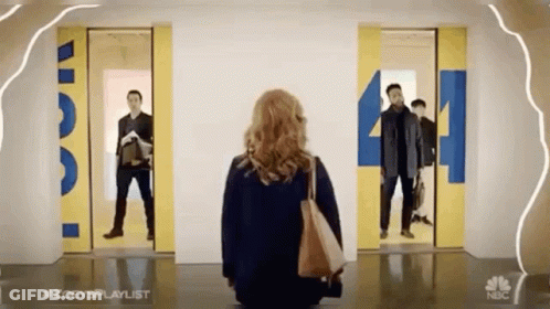 Woman By Two Elevators With Number 4 GIF