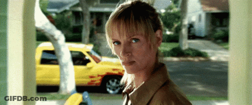 Woman By Yellow Truck Looking At Camera GIF