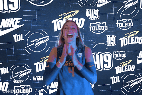 Woman Clapping In Front Of Nike Toledo Wall GIF