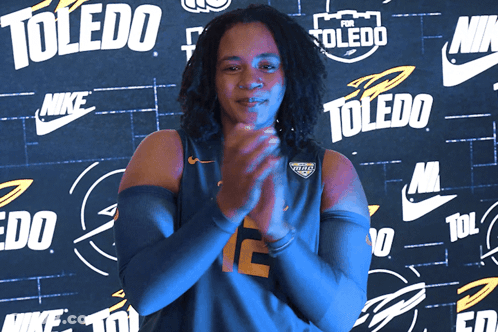 Woman Clapping In Front Of Toledo Wall GIF