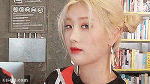 Woman Close Up In Front Of Bookshelf GIF