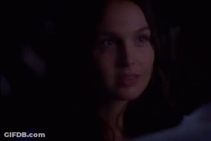 Woman Close Up Smiling In Dark GIF