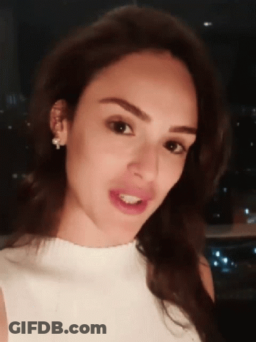Woman Close Up With White Shirt And Earrings GIF