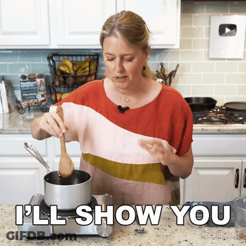Woman Cooking In Kitchen Saying Ill Show You GIF